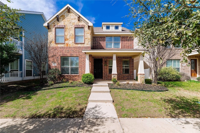 traditional-style home with a front lawn, brick siding, and stone siding