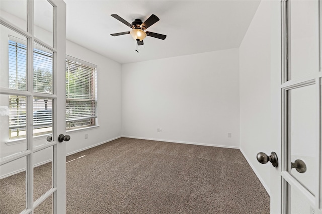 unfurnished room featuring a ceiling fan, baseboards, and carpet floors