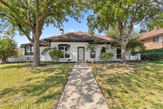 3005 Club Hill Dr, Garland, TX 75043 - view of front of home featuring brick siding, a front yard, and a chimney