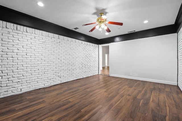 3005 Club Hill Dr, Garland, TX 75043 - empty room featuring visible vents, brick wall, baseboards, dark wood-style floors, and a ceiling fan