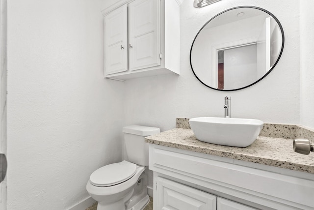 3005 Club Hill Dr, Garland, TX 75043 - bathroom featuring toilet, vanity, and a textured wall