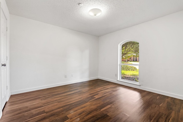 3005 Club Hill Dr, Garland, TX 75043 - spare room featuring baseboards, a textured ceiling, and dark wood finished floors