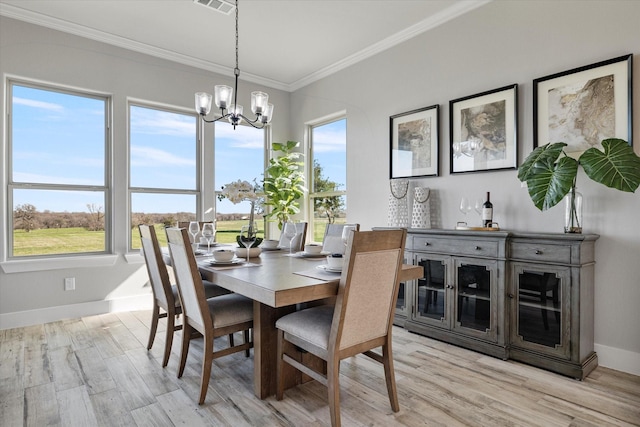 dining space with a notable chandelier, light wood-style floors, and plenty of natural light