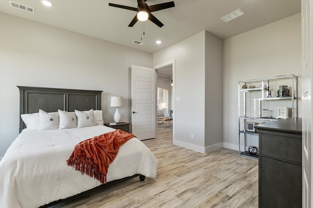 bedroom with visible vents, baseboards, and light wood-style floors