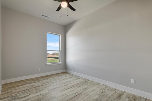 spare room featuring visible vents, baseboards, light wood-style floors, and ceiling fan