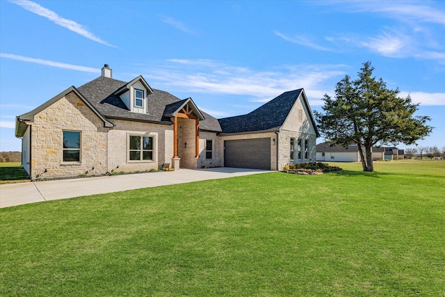 view of front of home with driveway, an attached garage, a chimney, a front lawn, and stone siding