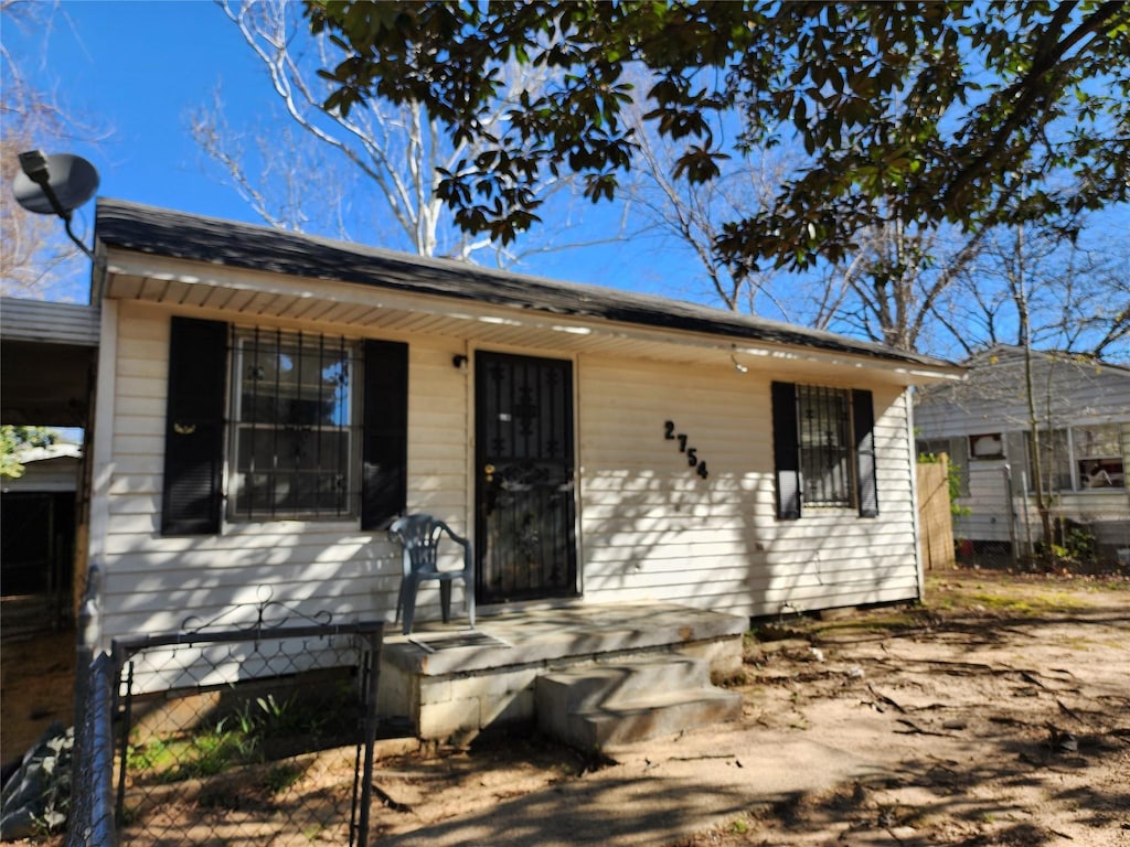 rear view of house with fence