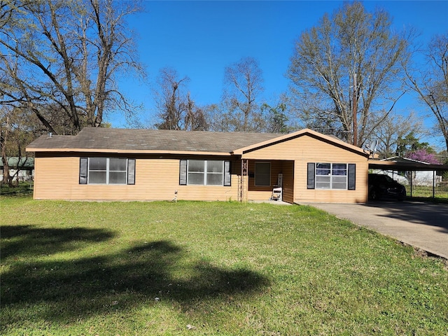 ranch-style house featuring a carport, concrete driveway, and a front yard