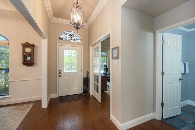 804 Park Hill Dr, Euless, TX 76040 - entrance foyer with a chandelier, dark wood-style floors, baseboards, and ornamental molding