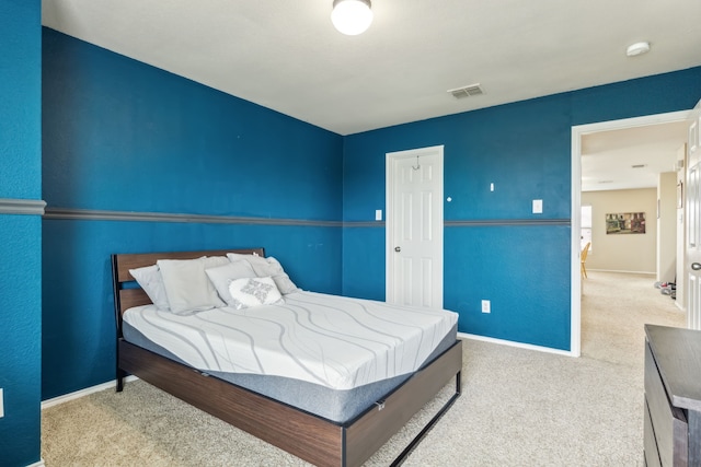 carpeted bedroom with baseboards and visible vents
