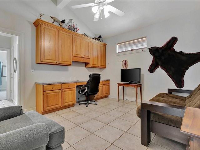 office area featuring built in desk, light tile patterned floors, a ceiling fan, and lofted ceiling