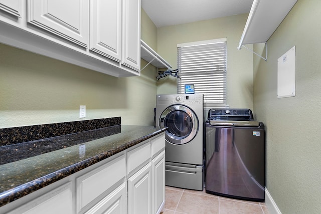 104 Petes Ln, Ponder, TX 76259 - laundry area with washing machine and dryer, light tile patterned floors, and cabinet space