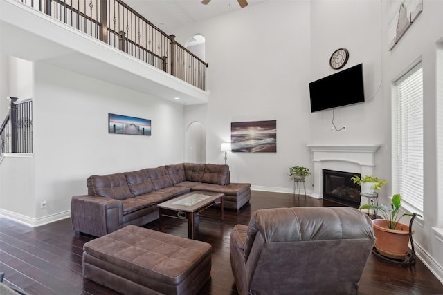 140 Dogwood Dr, Krugerville, TX 76227 - living room with baseboards, a ceiling fan, a towering ceiling, and wood-type flooring