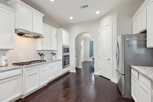140 Dogwood Dr, Krugerville, TX 76227 - kitchen featuring visible vents, under cabinet range hood, stainless steel appliances, arched walkways, and white cabinetry
