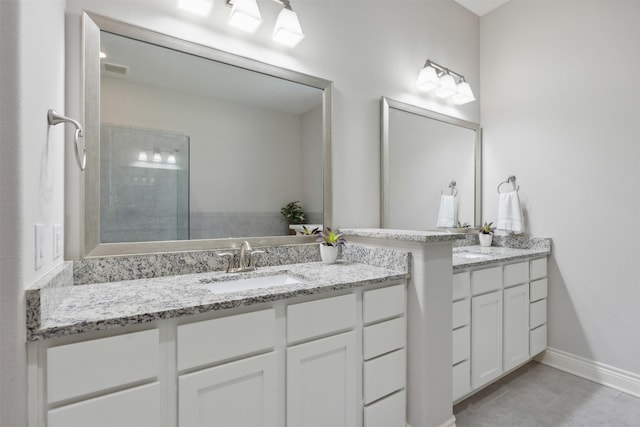 140 Dogwood Dr, Krugerville, TX 76227 - bathroom featuring vanity, visible vents, baseboards, a tile shower, and tile patterned flooring