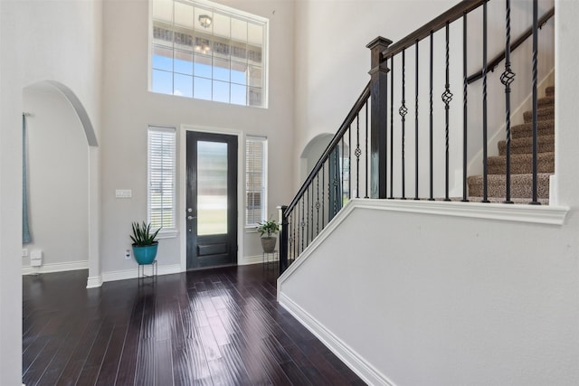 140 Dogwood Dr, Krugerville, TX 76227 - foyer entrance with baseboards, stairs, a towering ceiling, wood finished floors, and arched walkways