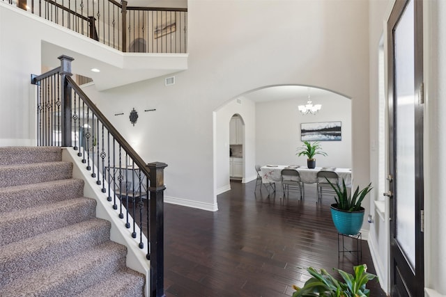 140 Dogwood Dr, Krugerville, TX 76227 - staircase with visible vents, wood finished floors, arched walkways, and a towering ceiling