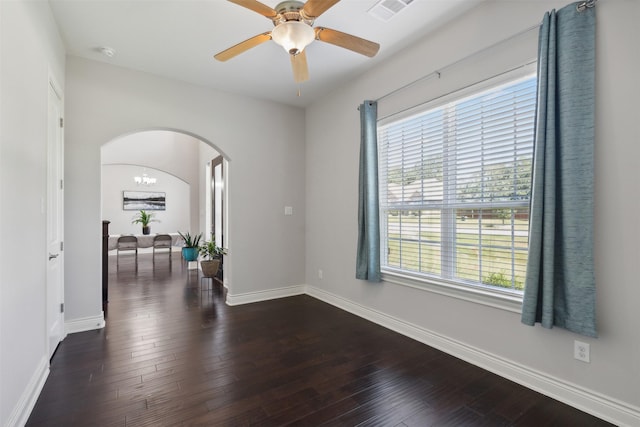 140 Dogwood Dr, Krugerville, TX 76227 - unfurnished room featuring a healthy amount of sunlight, visible vents, arched walkways, dark wood-style flooring, and ceiling fan