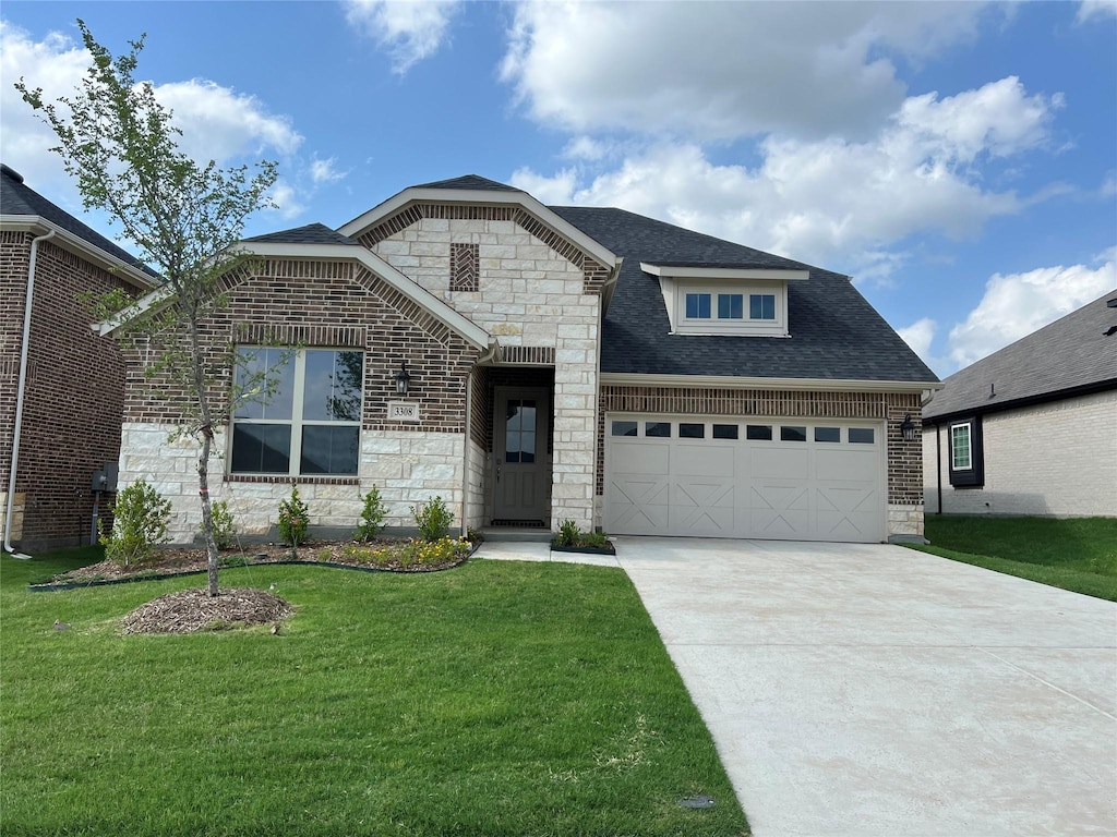 3308 Cross Shore Dr, Anna, TX 75409 - french country style house featuring stone siding, an attached garage, driveway, a front yard, and a shingled roof