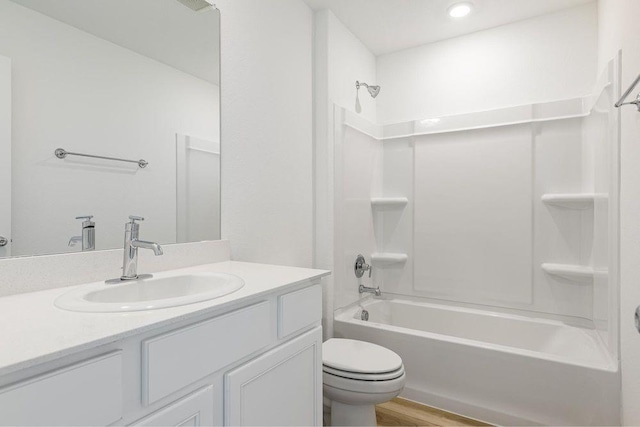 bathroom featuring vanity, wood finished floors, toilet, and tub / shower combination