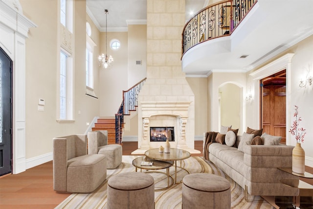living area featuring visible vents, crown molding, baseboards, stairs, and wood finished floors