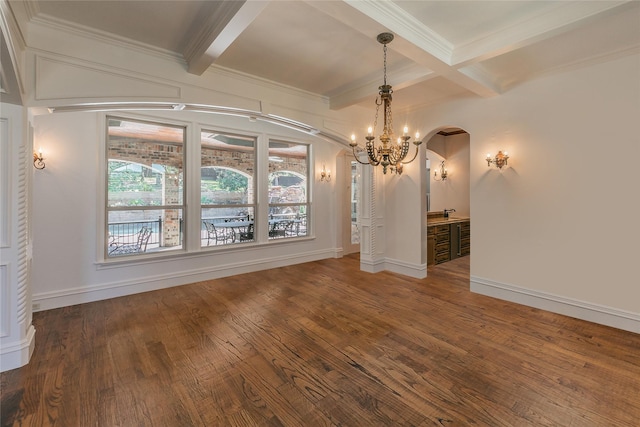 unfurnished dining area with hardwood / wood-style flooring, baseboards, arched walkways, and a chandelier