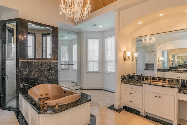 bathroom featuring a jetted tub, a notable chandelier, visible vents, and a stall shower