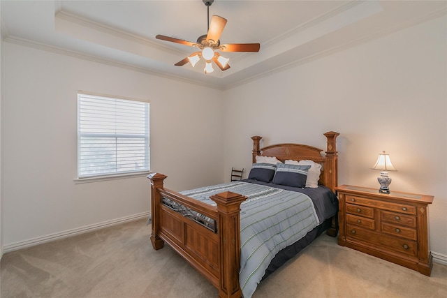 bedroom featuring baseboards, ceiling fan, crown molding, light carpet, and a raised ceiling