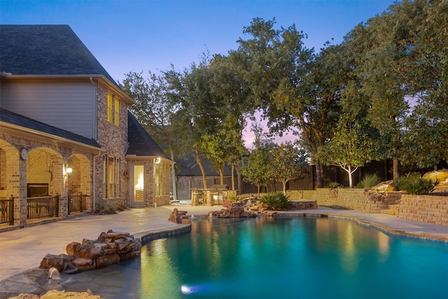 view of swimming pool with a fenced backyard, a fenced in pool, and a patio