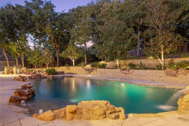 view of swimming pool with a fenced in pool, a water slide, a fenced backyard, and a patio area