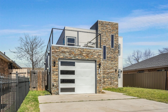 3725 Toronto St, Dallas, TX 75212 - exterior space featuring stone siding, an attached garage, driveway, and fence