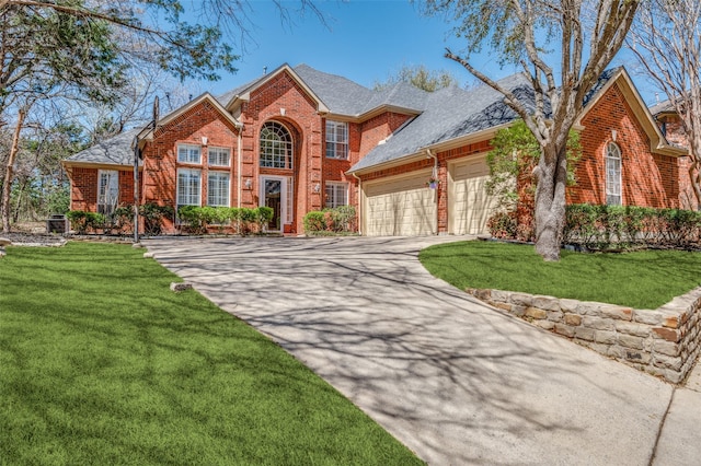 313 Appalachian Way, Mckinney, TX 75071 - view of front of home with brick siding, a garage, concrete driveway, roof with shingles, and a front lawn