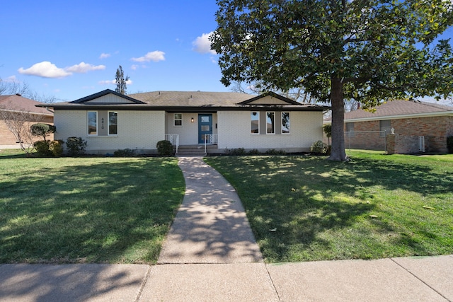 view of front of property with a front yard and brick siding