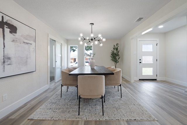 dining space featuring an inviting chandelier, a wealth of natural light, and baseboards