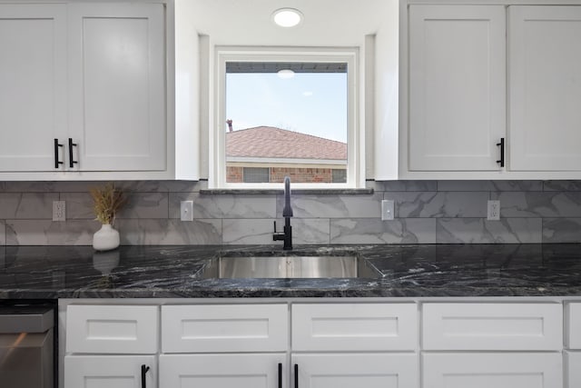 kitchen with white cabinetry and a sink