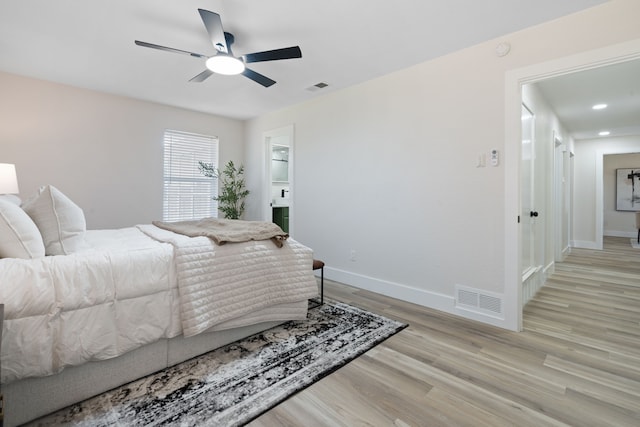 bedroom with visible vents, baseboards, and light wood-type flooring