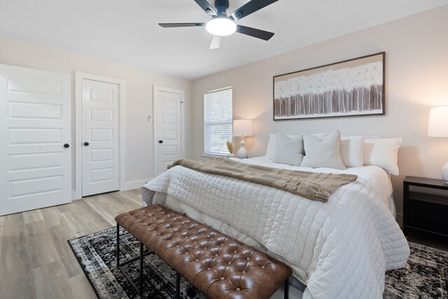 bedroom featuring baseboards, ceiling fan, and light wood-style floors