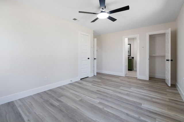 unfurnished bedroom with baseboards, visible vents, a ceiling fan, and light wood-type flooring