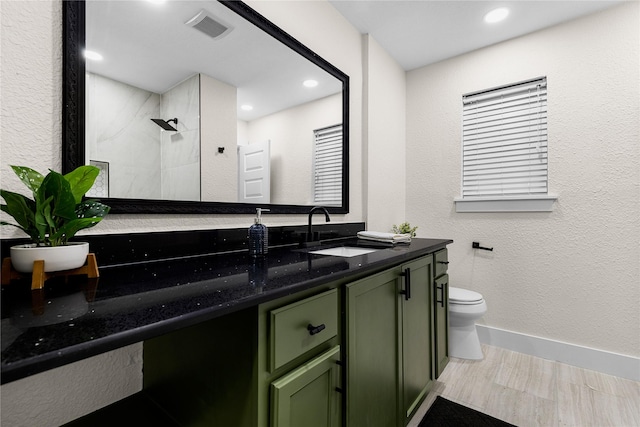 6410 Symphony Ln, Dallas, TX 75227 - full bath with toilet, vanity, a tile shower, recessed lighting, and a textured wall