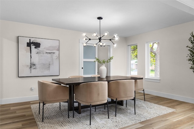 6410 Symphony Ln, Dallas, TX 75227 - dining area with baseboards, a chandelier, and wood finished floors