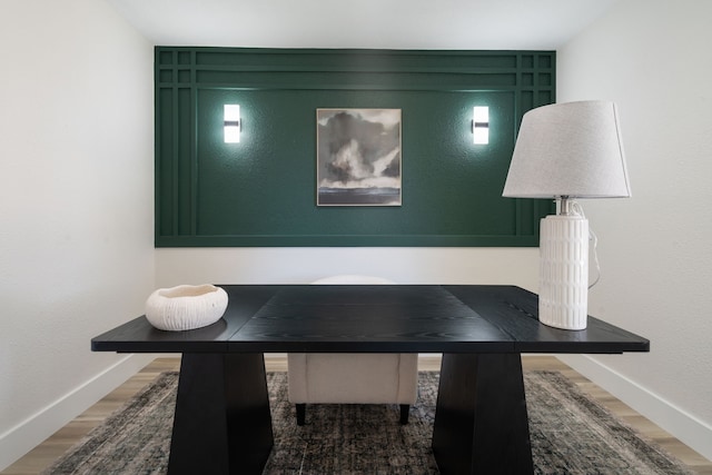 dining area with wood finished floors and baseboards