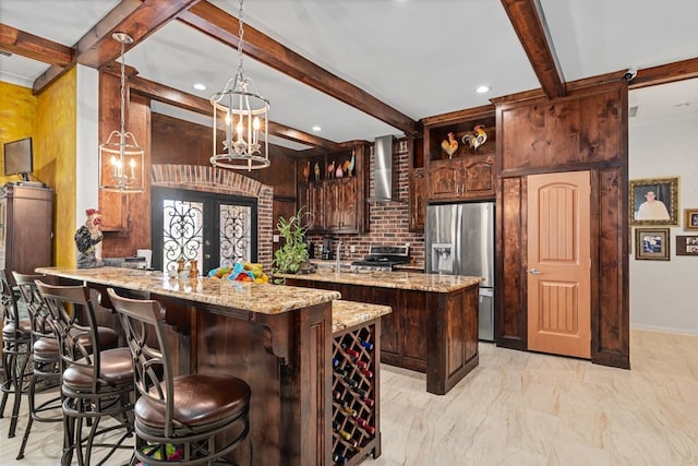 17909 Terrace Dr, Kemp, TX 75143 - kitchen with a center island, a peninsula, stainless steel fridge with ice dispenser, wall chimney range hood, and range