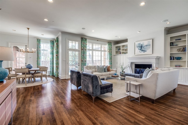 4517 N Versailles Ave, Highland Park, TX 75205 - living area featuring ornamental molding, a chandelier, built in shelves, dark wood finished floors, and healthy amount of natural light