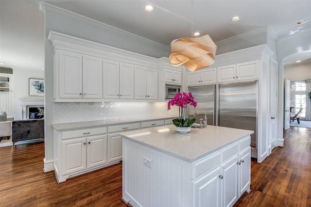 4517 N Versailles Ave, Highland Park, TX 75205 - kitchen featuring appliances with stainless steel finishes, dark wood finished floors, white cabinetry, a center island, and recessed lighting