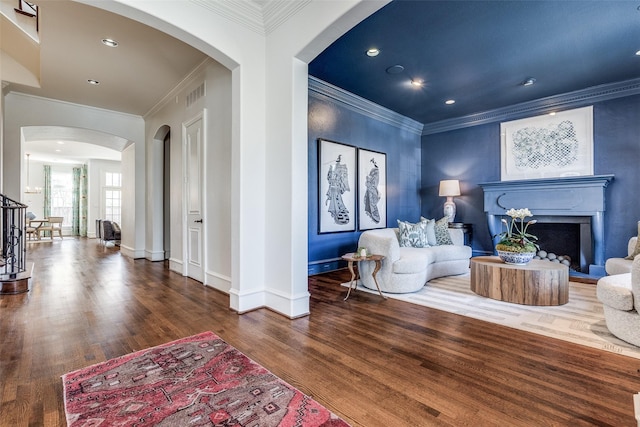 4517 N Versailles Ave, Highland Park, TX 75205 - living room with crown molding, a fireplace, wood finished floors, arched walkways, and recessed lighting