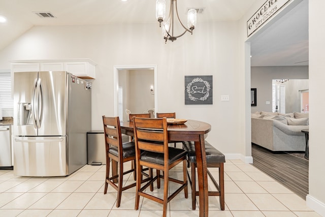 6409 Cypress Ln, Rowlett, TX 75087 - dining space featuring visible vents, an inviting chandelier, light tile patterned flooring, baseboards, and vaulted ceiling