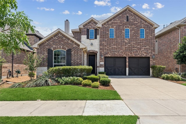 816 Sandbox Dr, Little Elm, TX 76227 - view of front facade featuring brick siding, driveway, a garage, a chimney, and a front lawn