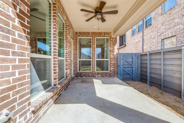 view of patio / terrace featuring a ceiling fan and a gate