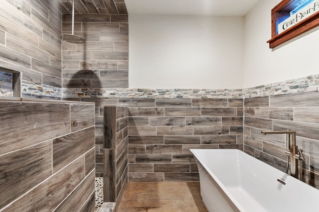 full bathroom with tile walls, a soaking tub, and a tile shower