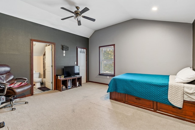bedroom featuring baseboards, ceiling fan, lofted ceiling, light carpet, and ensuite bath